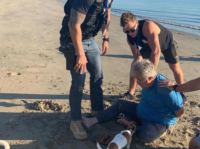 Disgraced businessman and conman Peter Foster is arrested by detectives on a Port Douglas beach this morning. Picture: Daily Telegraph