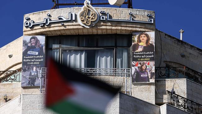 Pictures of the slain Palestinian journalist Shireen Abu Akleh are hung across the facade of the building housing the Al Jazeera TV channel in the occupied West Bank city of Ramallah on Thursday. Picture: AFP