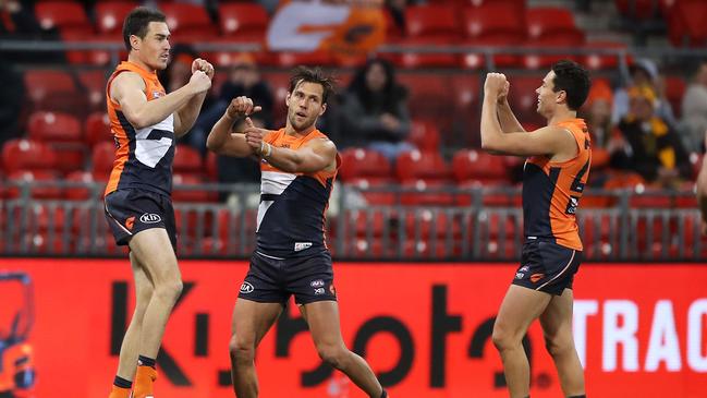 Jeremy Cameron celebrates kicking a goal with Giants teammates Matt De Boer and Josh Kelly against the Hawks. Picture: Mark Kolbe/Getty Images