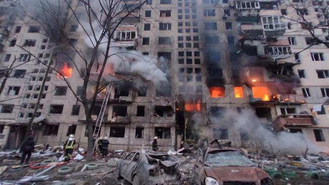 Rescuers work next to a residential building damaged by shelling in Kyiv on Monday.   Picture: AFP