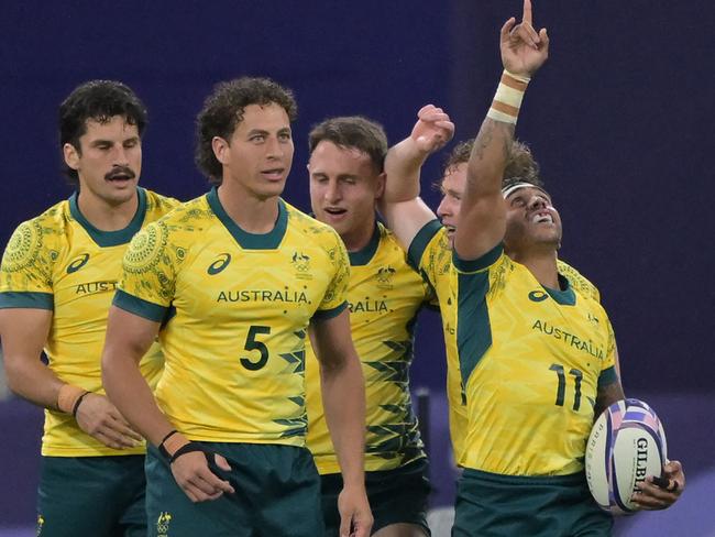 Australian players celebrate winning their men's quarter-final clash against USA. Picture: AFP