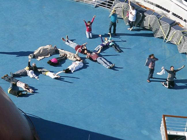 Passengers spell out the word HELP on the disabled Carnival Lines cruise ship Triumph. Picture: Gerald Herbert