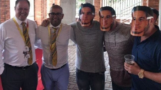 Cricket South Africa officials Clive Eksteen and Altaaf Kazi pose with fans wearing Sonny Bill Williams masks.