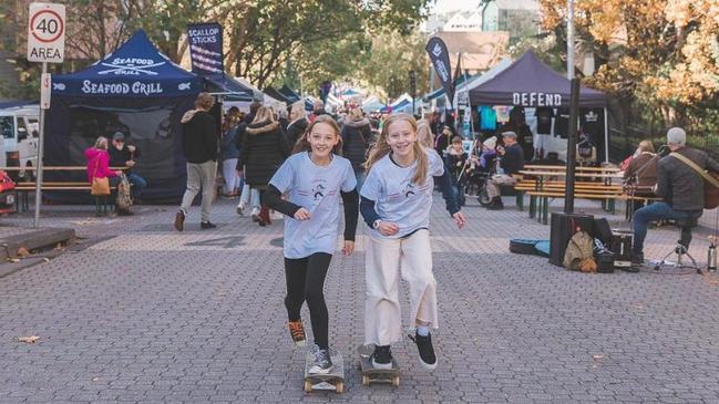 Charlotte Leppard and Zailee Jackson both 13 'shredding for CF' at Salamanca Market. Picture: supplied