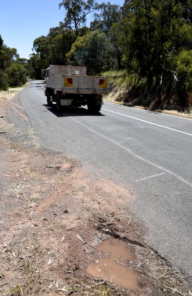 A large pot hole on Mansfield-Woods Point Rd near where four people died in a car crash in November 2023. Picture: Andrew Henshaw