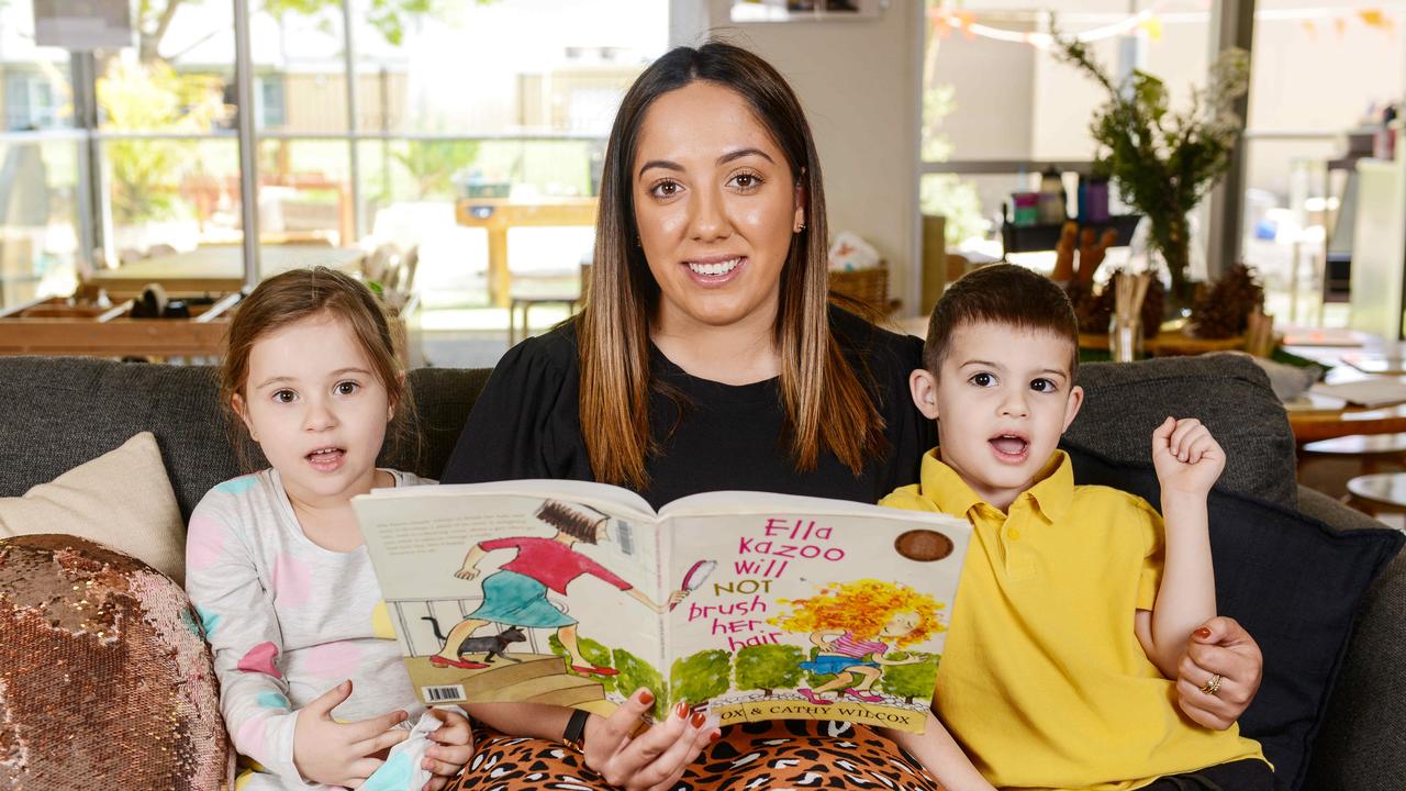 Daniella and Jozef read a book with educator Emma Lagana at Nazareth Catholic Community - Early Childhood Centre in Findon. The centre is now one of five centres in the state with the top rating 'excellent'. Picture: Brenton Edwards