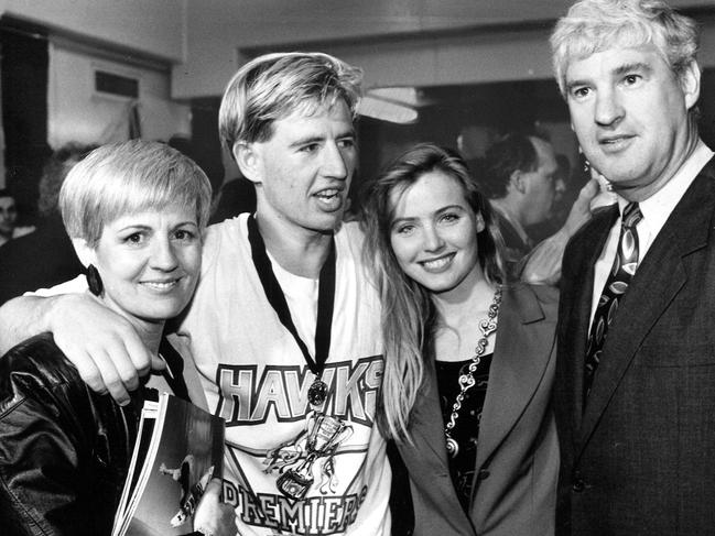 Paul Hudson with Mum Stephanie, girlfriend Jenny Gole and dad Peter after Hawthorn won the 1991 grand final. [Herald Sun 30/09/1991]