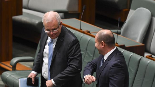 Scott Morrison and Josh Frydenberg elbow bump after the introduction of the coronavirus Economic Response Package in parliament this week. Picture: AAP