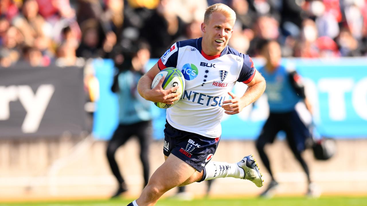 Andrew Deegan of the Rebels runs with the ball to score at Level Five Stadium.