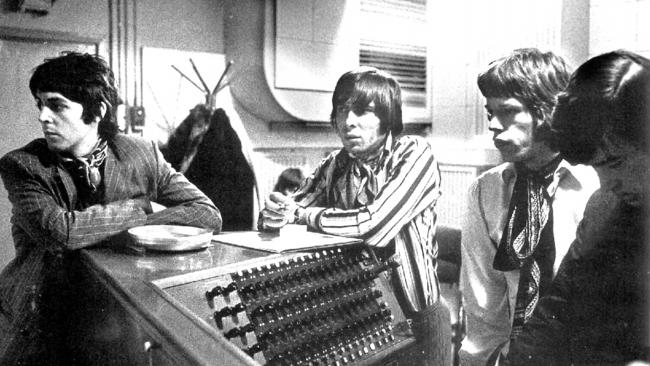 Paul McCartney (left) at a Rolling Stones recording session with producer Glyn Johns (centre) and Stones frontman Mick Jagger (second from right) during the 1960s.