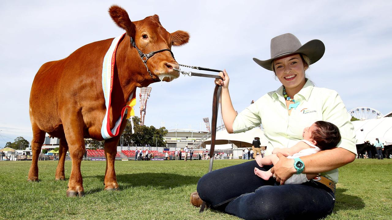 Hayleigh Duvall holds both her 3-week-old daughter Aria and her Limousin cow that won the Urquhart Trophy in the Beef Championships this year. Picture: Toby Zerna