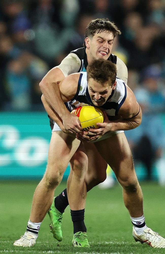 Tom Atkins tries to shake off Zak Butters. Picture: Sarah Reed/AFL Photos via Getty Images