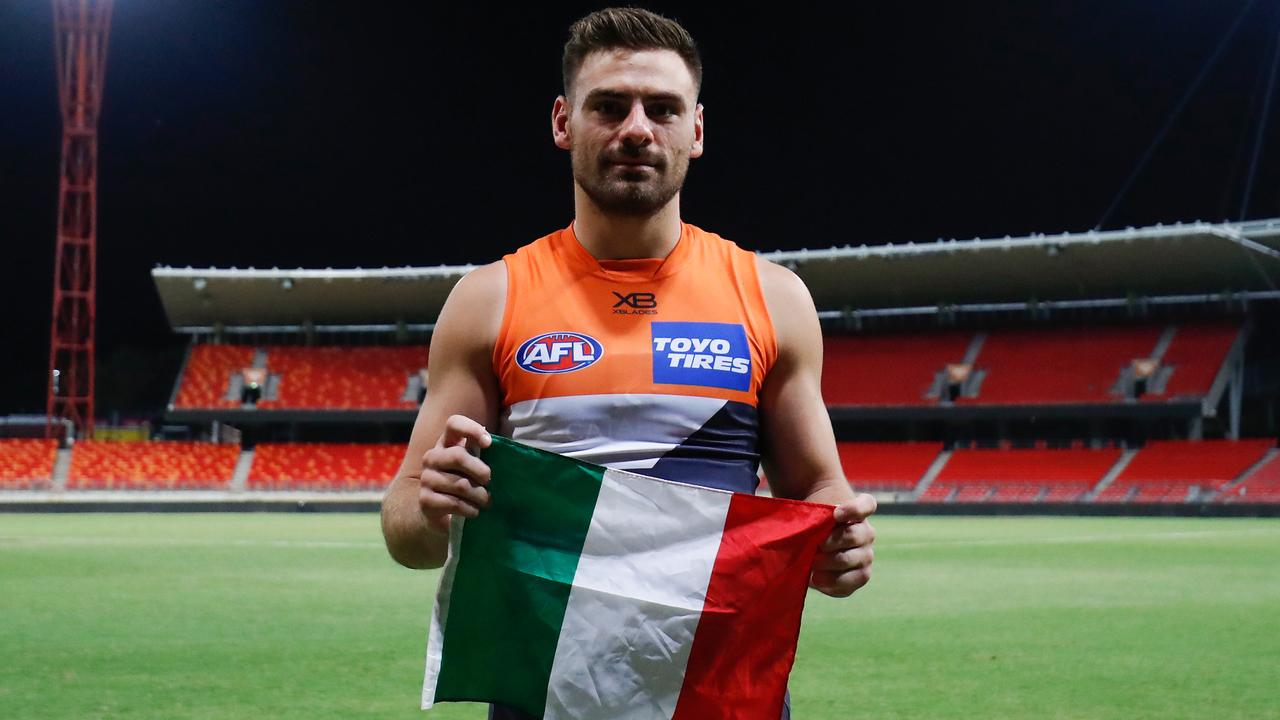 Stephen Coniglio poses with an Italian flag following the Round 1 win over Geelong.