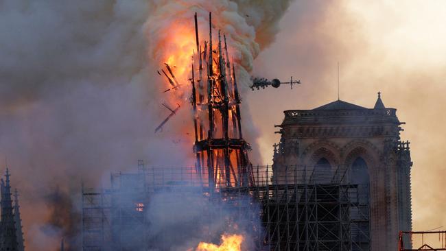 The steeple collapses as smoke and flames engulf the Notre-Dame Cathedral. Picture: AFP.