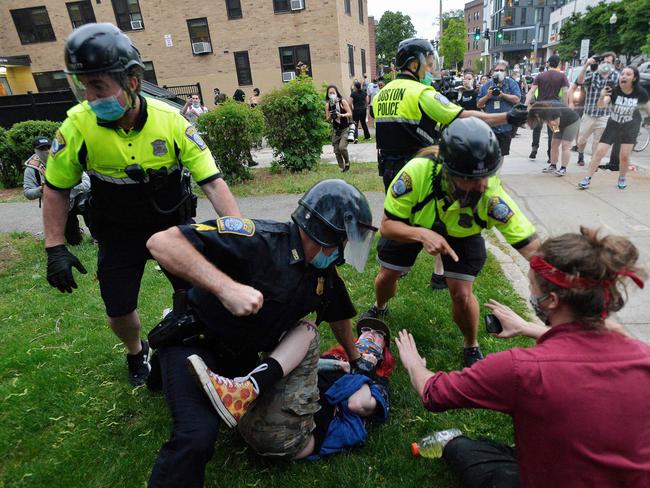 A police officer holds down a protester while another (back) sprays pepper spray as they clash outside the District Four Police station during a Black Lives Matter protest against police brutality and racism in the US, in Boston, Massachusetts. Picture: AFP