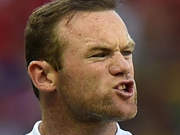 (FILES) In a file picture taken on June 24, 2014 England's forward Wayne Rooney reacts during the Group D football match between Costa Rica and England at The Mineirao Stadium in Belo Horizonte during the 2014 FIFA World Cup. England captain Rooney will become England's ninth centurion when he leads his country out against Slovenia at Wembley in the Euro 2016 qualifier for his 100th cap on November 15, 2014. AFP PHOTO / BEN STANSALL