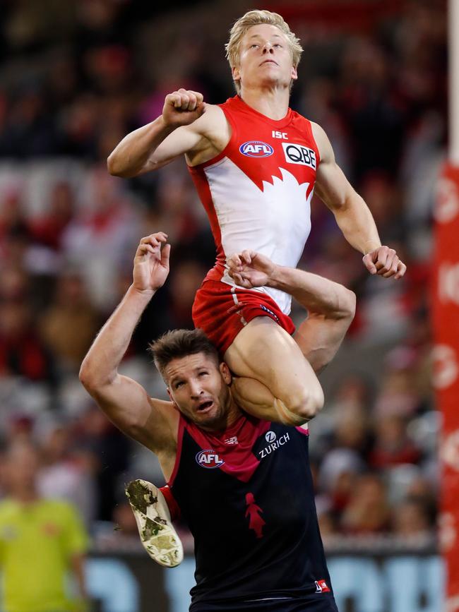 Isaac Heeney takes a spectacular grab over Jesse Hogan.