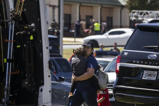 Parents arrive to pick up their children after the shooting took place at Apalachee High School in Winder, Georgia