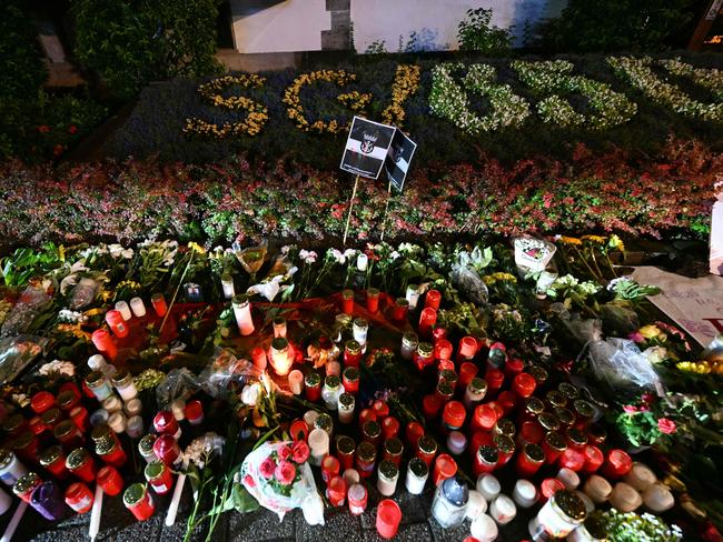 Candles and flowers left near the area where three people were killed and several injured during a knife attack during an arts festival in Solingen. Picture: AFP