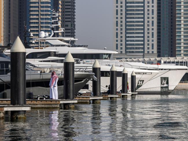 A visitor dockside by luxury motor yachts moored at the Dubai International Boat Show in Dubai, United Arab Emirates, on Wednesday, March 9, 2022. The show, taking place in Dubai Marina, runs from March 9-13. Photographer: Christopher Pike/Bloomberg