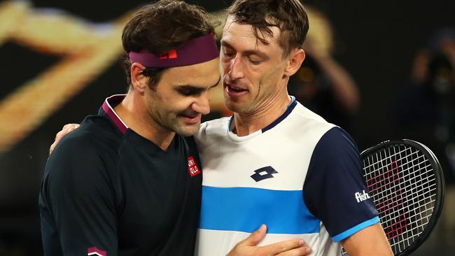 Roger Federer consoles John Millman after their Australian Open epic.