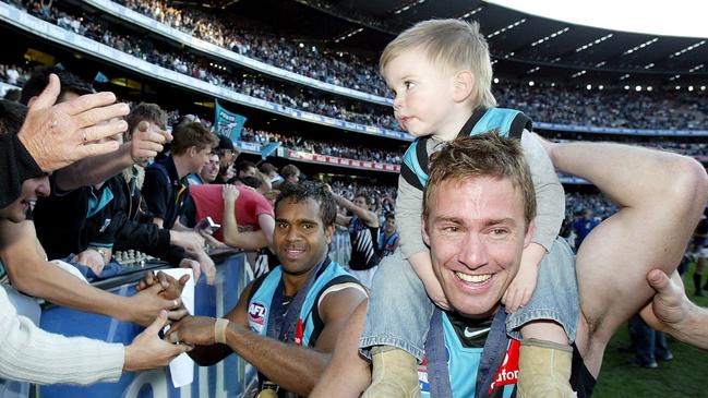 Jarrad Schofield with his son Taj after Port Adelaide’s 2004 AFL grand final win.