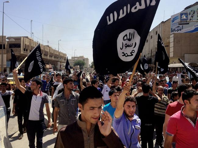 Our target ... emonstrators chant pro-Islamic State group slogans as they carry the group's flags in front of the provincial government headquarters in Mosul, northwest of Baghdad. Picture: AP