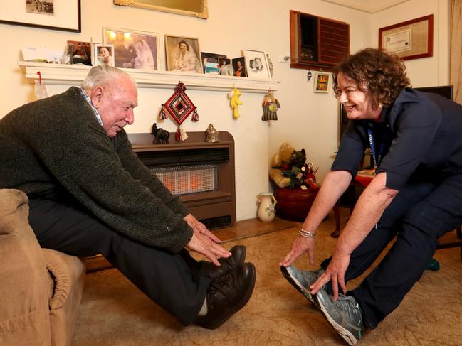 22/05/2020. Carer Liebe Shannon visiting Frank Holland-Stabback 99, at his home in Sandrigham, Melbourne. Picture: David Geraghty / The Australian.