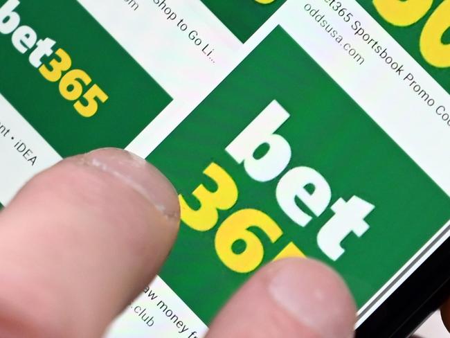 A man poses for a photograph with the online gambling website Bet365 displayed on a smartphone, in London on December 18, 2019. - Denise Coates, chief executive of British online betting giant Bet365, has retained her place as Britain's highest-paid boss, according to the group's annual report published on Wednesday. She was paid a basic salary of £277 million ($366 million, 328 million euros) in the group's financial year to March, the company's annual report showed. (Photo by Paul ELLIS / AFP)