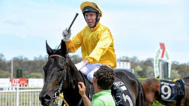 FINE FEAT: Jockey Ronnie Stewart shows his delight after riding Cymbalism to victory at Ipswich racetrack. Picture: Rob Williams