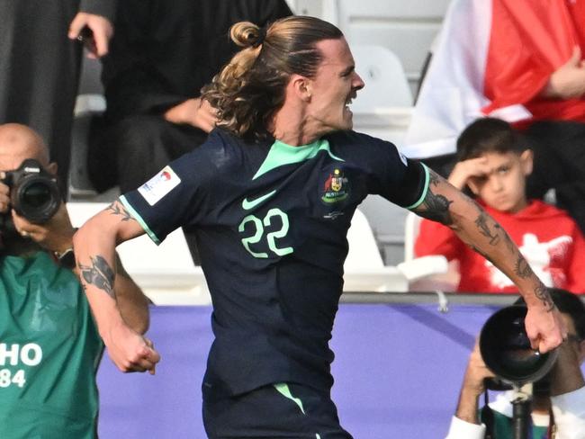 Australia's midfielder #22 Jackson Irvine celebrates after scoring his team's first goal during the Qatar 2023 AFC Asian Cup Group B football match between Syria and Australia at the Jassim bin Hamad Stadium in Doha on January 18, 2024. (Photo by HECTOR RETAMAL / AFP)