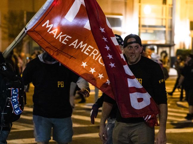 Members of Antifa and Proud Boys clash in the middle of the street following the Million MAGA March in Washington. Picture: Getty Images