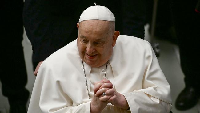 Pope Francis greets people at the end of the weekly general audience earlier in February.