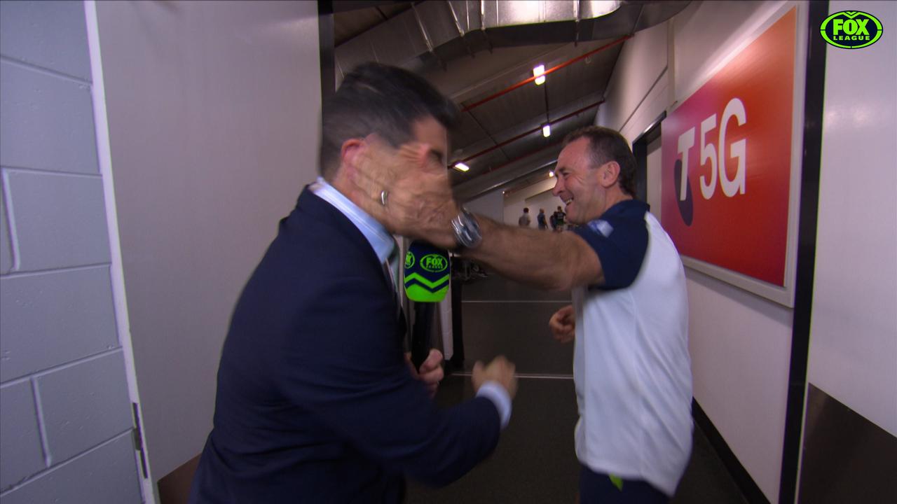Ricky Stuart gives Michael Ennis a quick slap in a pre-game interview.
