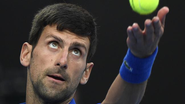 Novak Djokovic serves to Rafael Nadal as he takes out the first set. Picture: Andy Brownbill/AP