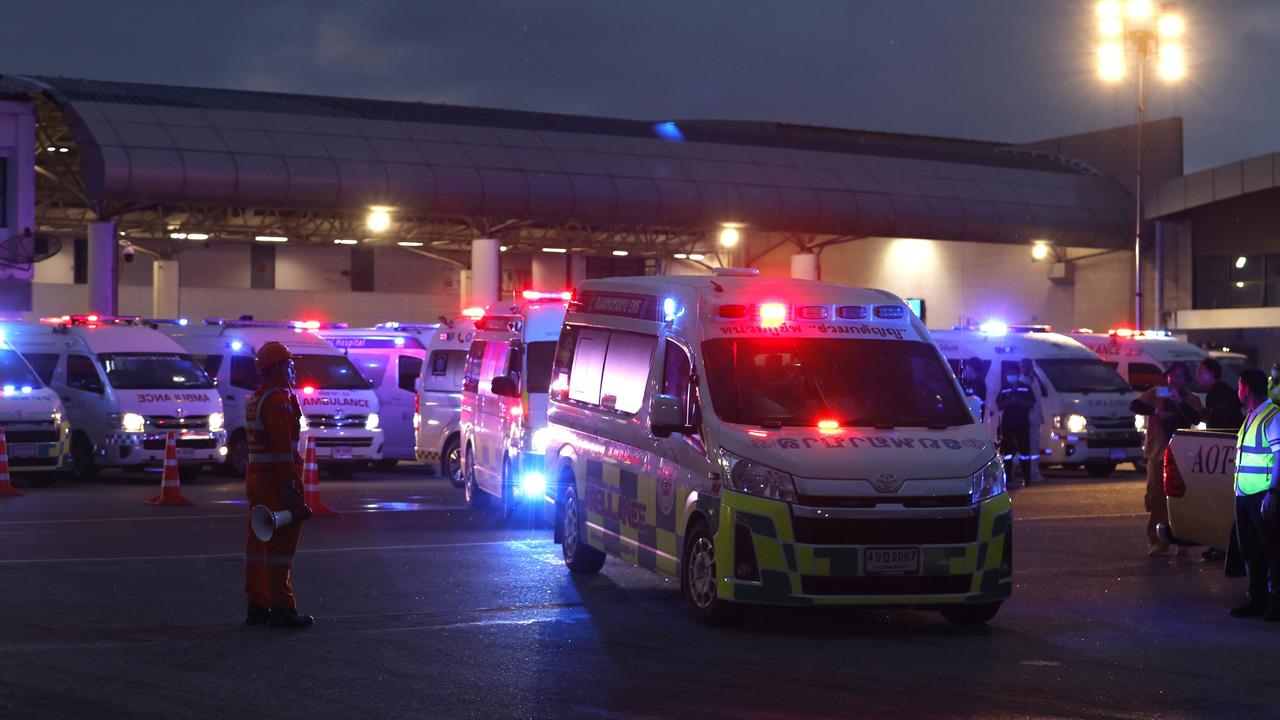 Ambulances took injured passengers from the plane to hospital after an emergency landing at Suvarnabhumi International Airport in Thailand. Picture: EPA/Rungroj Yongrit