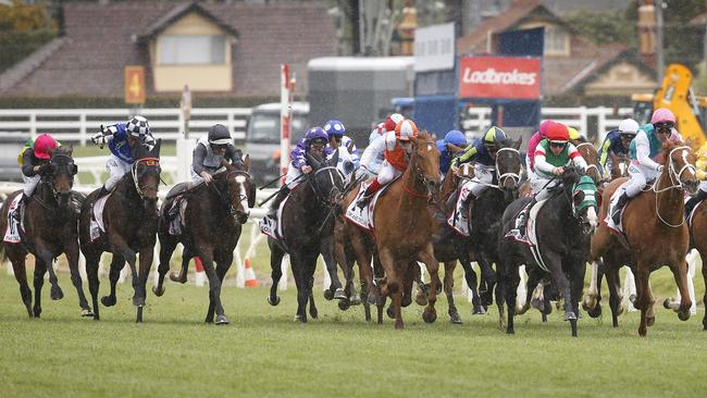 Constantinople (black sleeves and cap) stormed home to finish fourth in the Caulfield Cup. Picture: David Caird