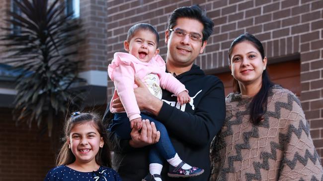 Gaurav and Kanika Bakshi Thind, with their children, Sara, 8, and Ayra, 13 months, at Quakers Hill. The family are waiting for their home to be built, which they bought before the rate hike. Picture: Justin Lloyd.