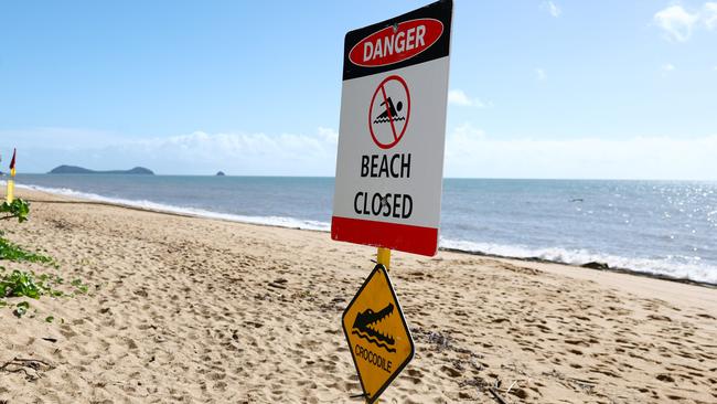 Trinity Beach was closed on Saturday morning when a small saltwater croc was seen swimming close to shore in the stinger net enclosure. Council lifeguards erected a Danger - Beach Closed sign after spotting the crocodile. Picture: Brendan Radke