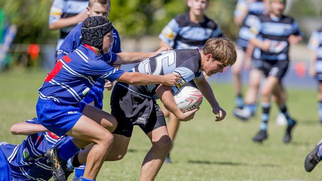 Day One of King of the Country rugby tournament at James Overell Park, Southport. Maroochydore Swans U14s' ( big stripes - blue) in action against USQ Saints U14s' (darker blue small stripes). Maroochydore Swans U14s Brock Combes . Picture: Jerad Williams