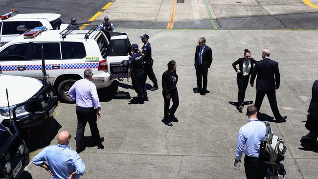 Queensland Police officers and detectives escort Rajwinder Singh from a chartered jet to a waiting police car at Cairns Airport after being extradited from New Delhi to Cairns via Melbourne. Picture: Brendan Radke