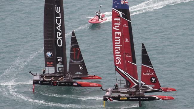 In this photo provided by the America's Cup Event Authority, Emirates Team New Zealand and Oracle Team USA compete.
