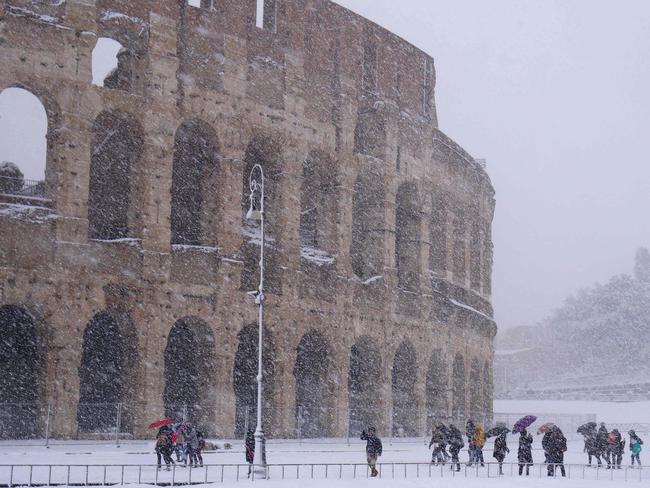 Tourists visit the Ancient Colisseum during a snowfall in Rome on February 26, 2018. Picture: AFP