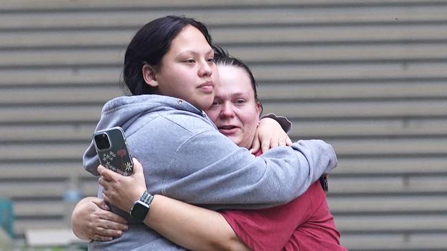 Families attempted to comfort each other outside the school. Picture: Allison Dinner / AFP.