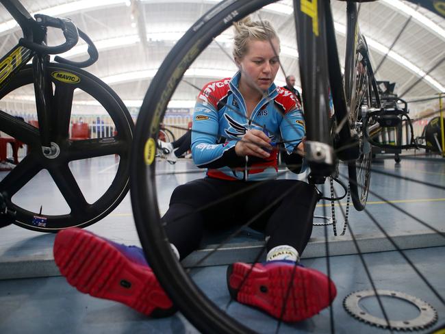 Stephanie Morton changes a wheel on her bike at the SuperDrome. Picture: Sarah Reed