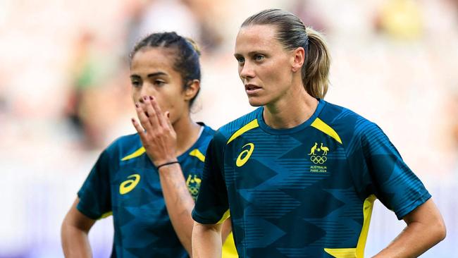 Australia's midfielder #10 Emily Van Egmond (C) looks on as her team warms up before the women's group B football match between Australia and Zambia during the Paris 2024 Olympic Games at the Nice Stadium in Nice on July 28, 2024. (Photo by Valery HACHE / AFP)