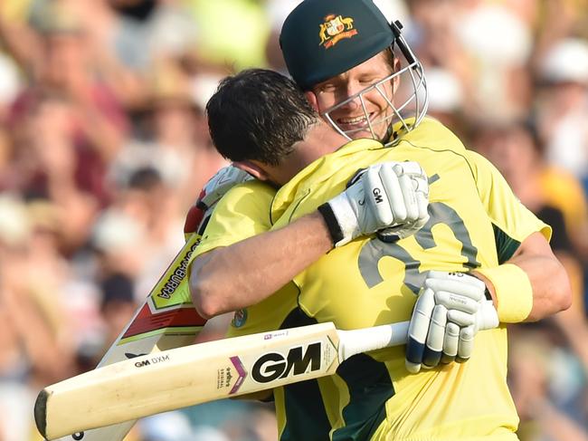 Australia batsman Glenn Maxwell (L) gets a hug from Shane Watson (R) after scoring a century during the 2015 Cricket World Cup Pool A match between Australia and Sri Lanka at the Sydney Cricket Ground on March 8, 2015. AFP PHOTO/Peter PARKS --IMAGE RESTRICTED TO EDITORIAL USE - STRICTLY NO COMMERCIAL USE--