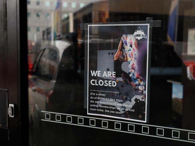 SYDNEY, AUSTRALIA - MARCH 26: A closed sign is displayed outside ClimbFit on March 26, 2020 in Sydney, Australia. ClimbFit gym is one of many indoor fitness facilities forced to close following the government's ban on indoor gatherings and non-essential services due to the COVID-19 pandemic. With Australia's number of confirmed cases approaching 3000 and the national COVID-19 death toll now at 12, Prime Minister Scott Morrison announced further measures to try and minimise the spread of coronavirus, requiring all libraries, museums, galleries, beauty salons, tattoo parlours, shopping centre food courts, auctions, open houses, amusement parks, arcades, indoor and outdoor play centres, swimming pools an indoor exercise venues to close on Wednesday. The closure of ClimbFit's two venues in Sydney has meant managing director Robbie Josephsen has had to lay off 50 casual staff members for the foreseeable future. The family-run business has been in operation for 25 years, but with no clear idea of when gyms will be able to reopen, the owners are unsure if they can continue to pay the rent on their two locations. (Photo by Brendon Thorne/Getty Images)