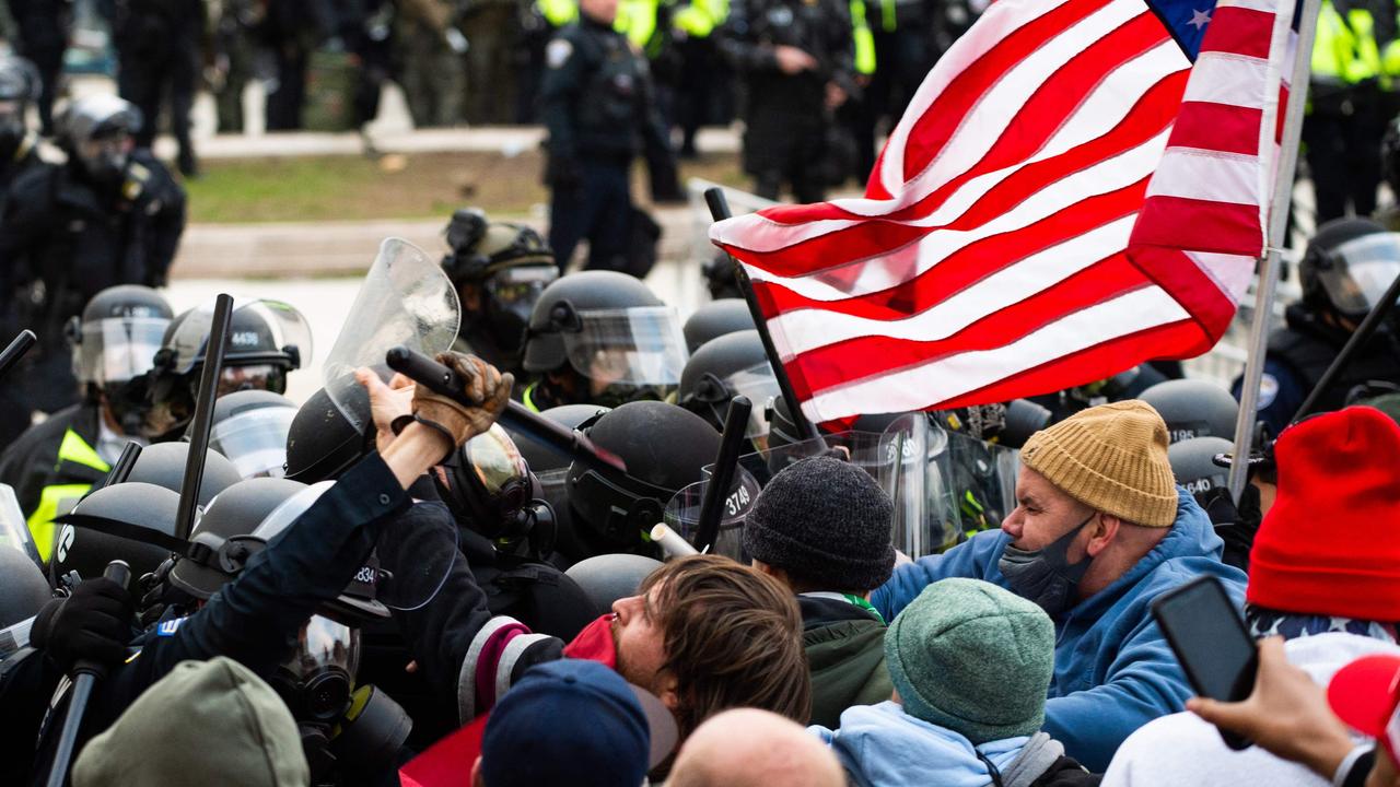 Trump supporters fight with riot police outside the Capitol building on January 6. Picture: Roberto Schmidt/AFP