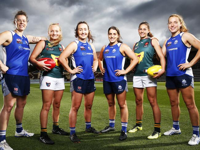 Tasmanian Devils under 18's players Brianna Oates, 17 and Tahlia Bortignon, 19 alongside Tasmanian AFLW Kangaroos players LR Britt Gibson, Nicole Bresnehan, Ellie Gavalas and Mia King ahead of today's games at North Hobart oval. Picture: Zak Simmonds